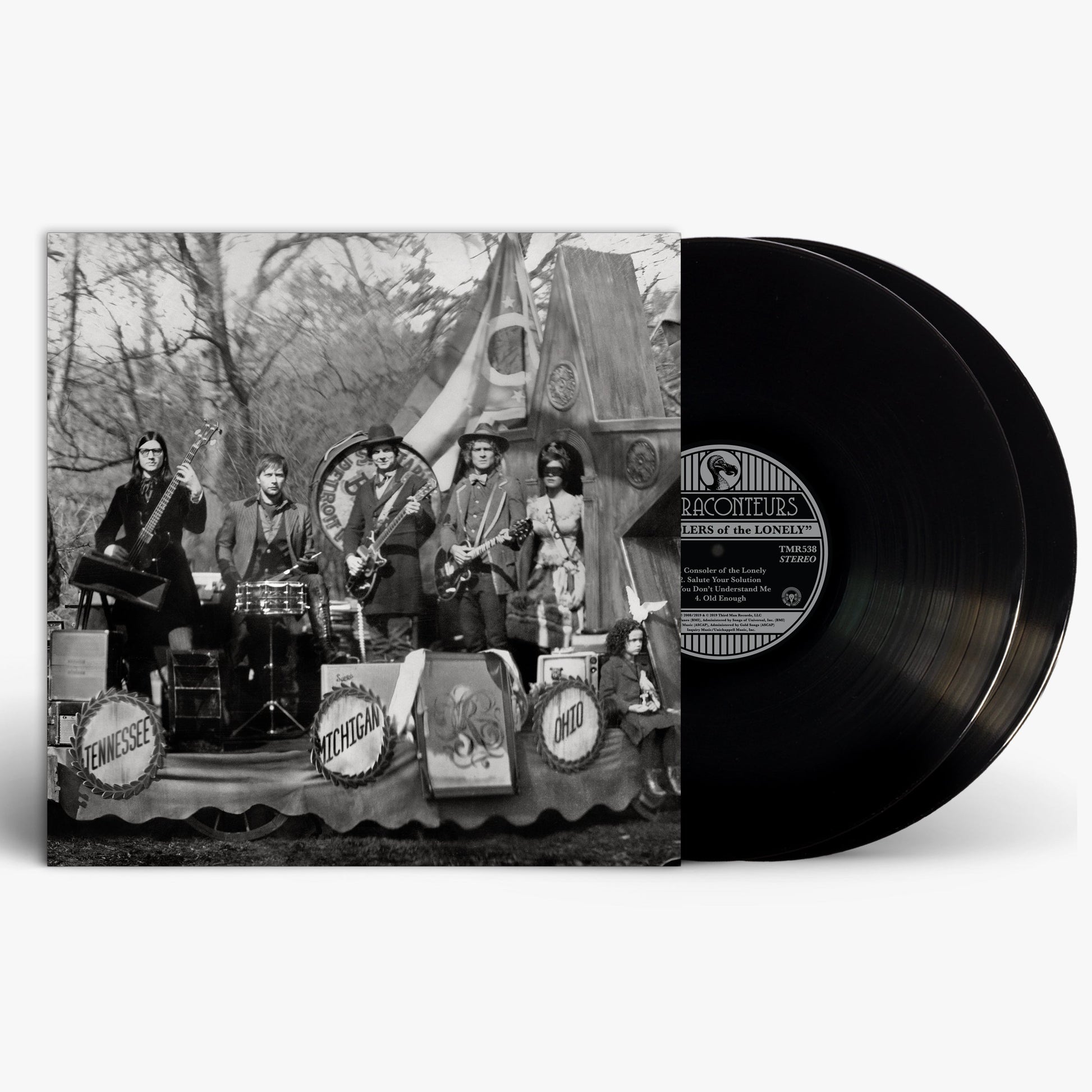 Black and white photo of The Raconteurs band posing with instruments.