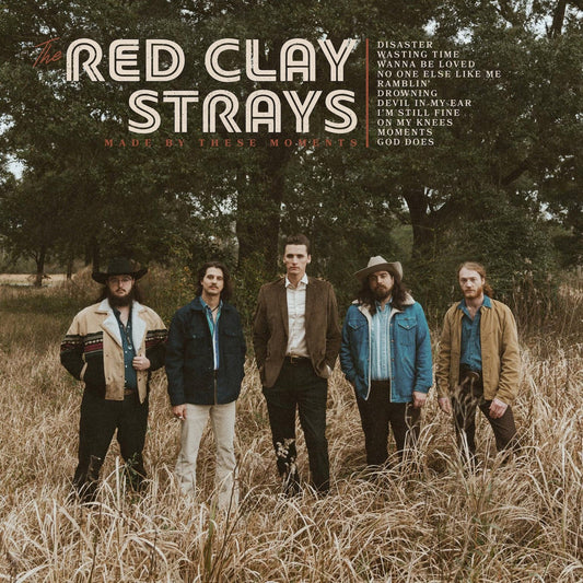 Five men stand in a field of tall grass with album title and tracklist overlay.