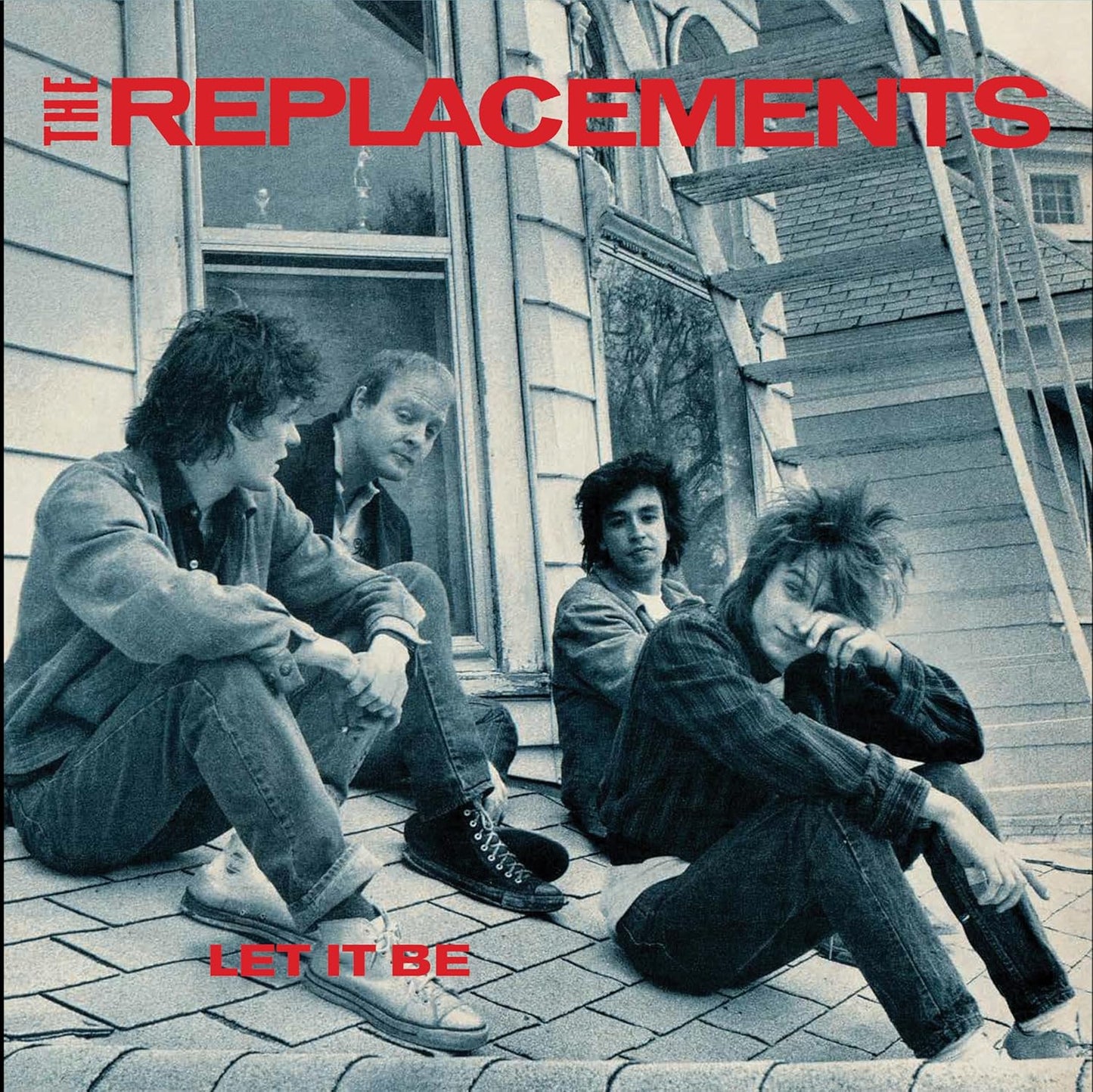 Black and white album cover featuring The Replacements sitting on steps.