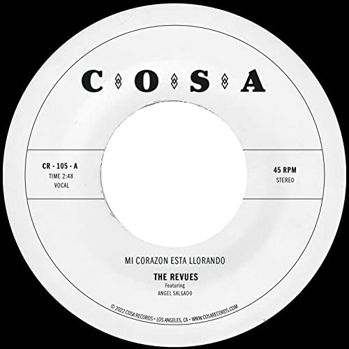 White vinyl record label with black text: "The Revues - Mi Corazon Esta Llorando".