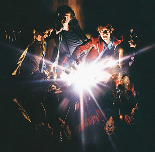 The Rolling Stones album cover, band members in dark setting with bright light.