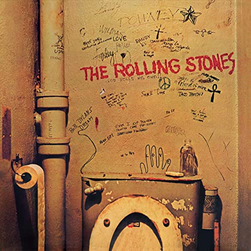 Graffiti-covered wall and toilet in a restroom, album cover for The Rolling Stones.