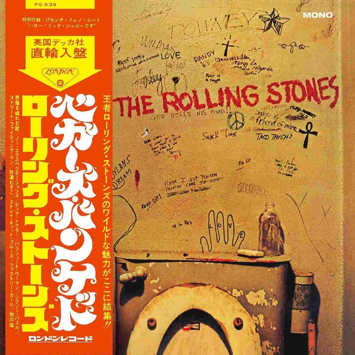 The Rolling Stones' album cover featuring a grimy bathroom wall with graffiti and a toilet.