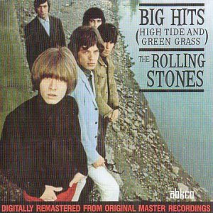 The Rolling Stones stand on a rocky embankment next to water on this album cover.