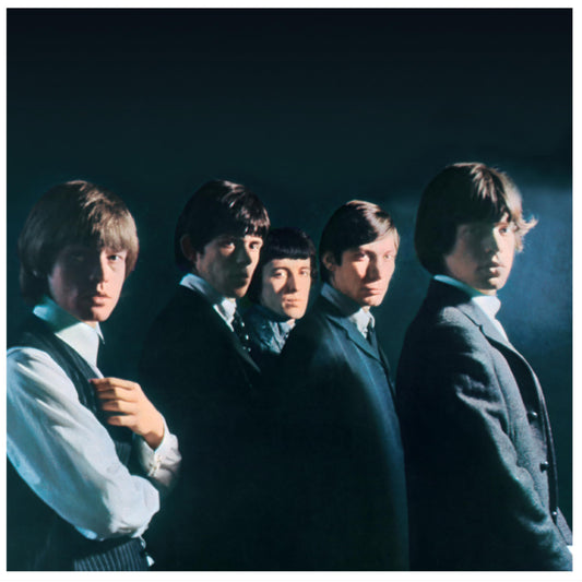 The Rolling Stones band portrait in dark suits, looking to the left.