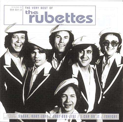 Black and white photo of The Rubettes wearing white caps and dark suits.