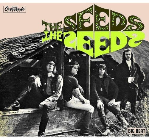 Black and white album cover featuring a band in front of a shack.