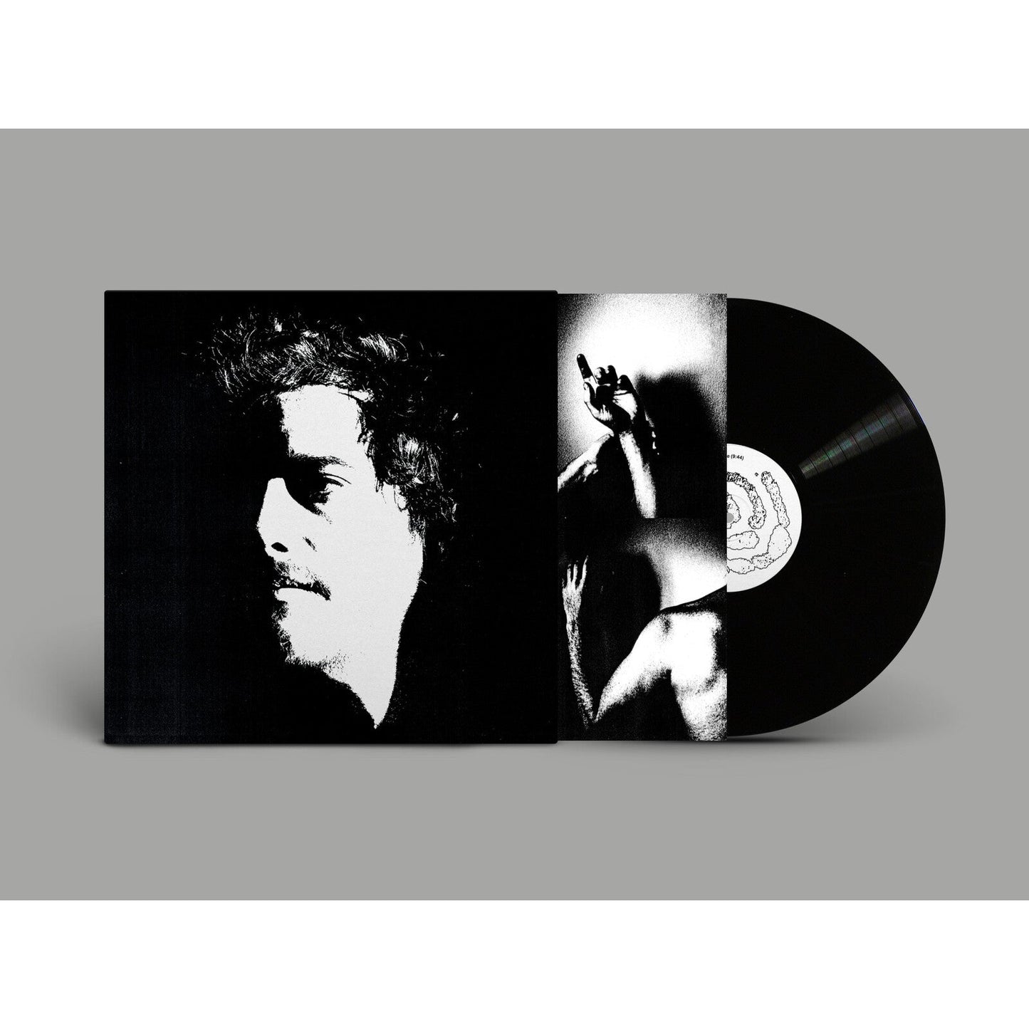 Vinyl record and open album cover with black and white portrait.