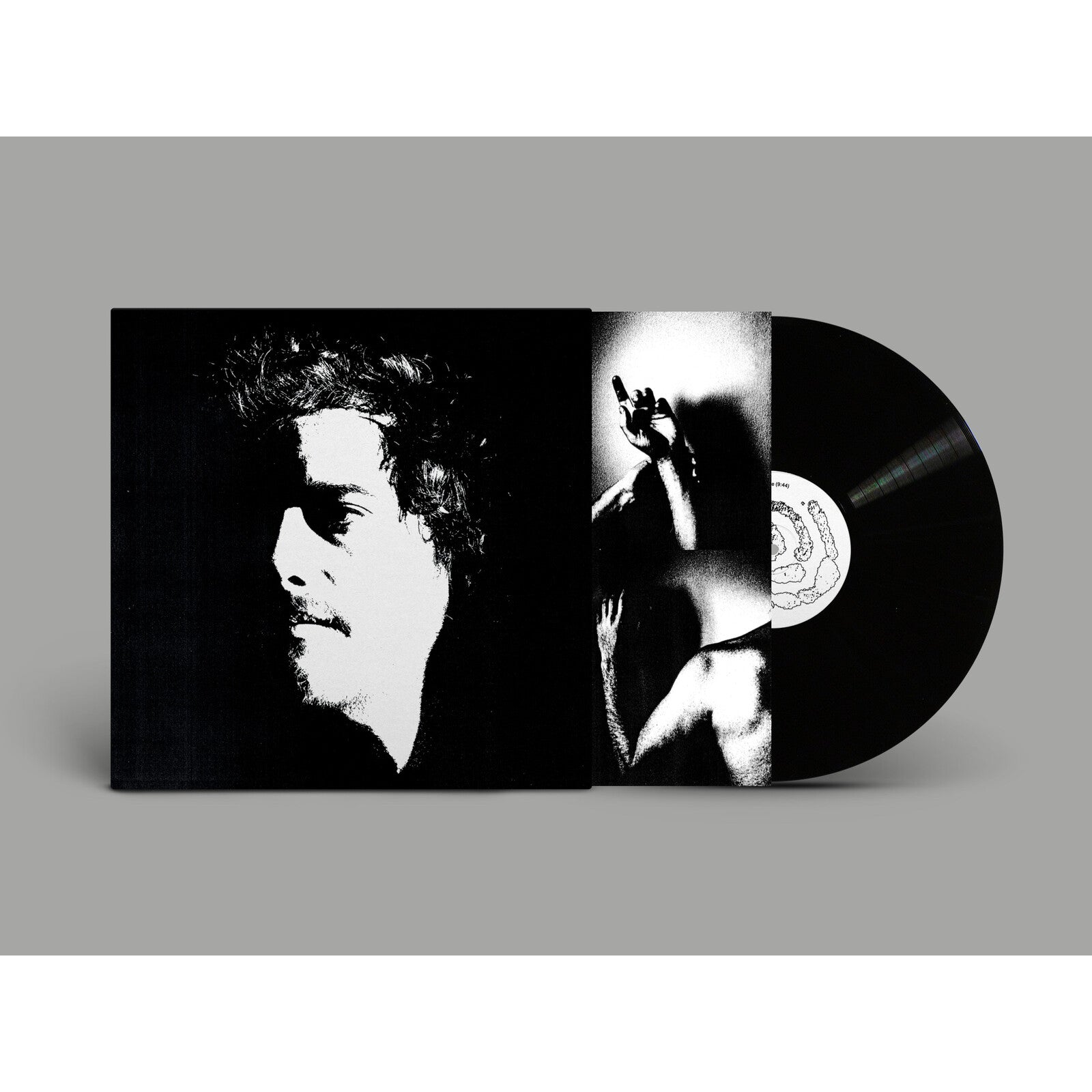 Vinyl record and open album cover with black and white portrait.