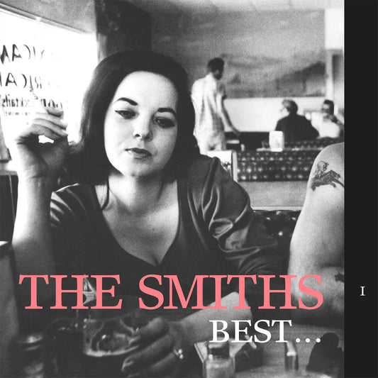 Black and white photo of a woman smoking in a diner with album text.
