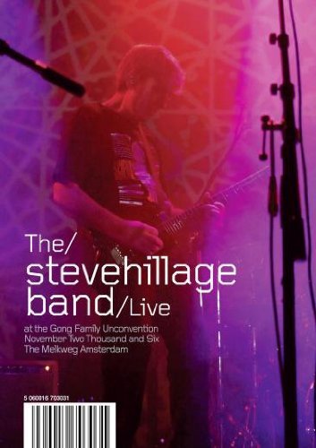 Steve Hillage playing guitar on stage under purple and red concert lighting.