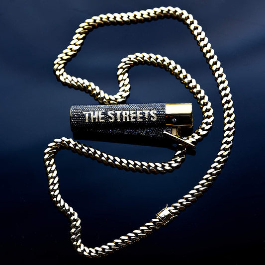 A gold chain wrapped around a black CD case with "THE STREETS" printed on it.
