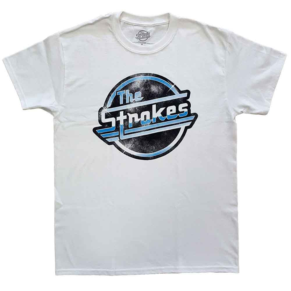 A man wearing a white t-shirt with a distressed blue The Strokes logo.