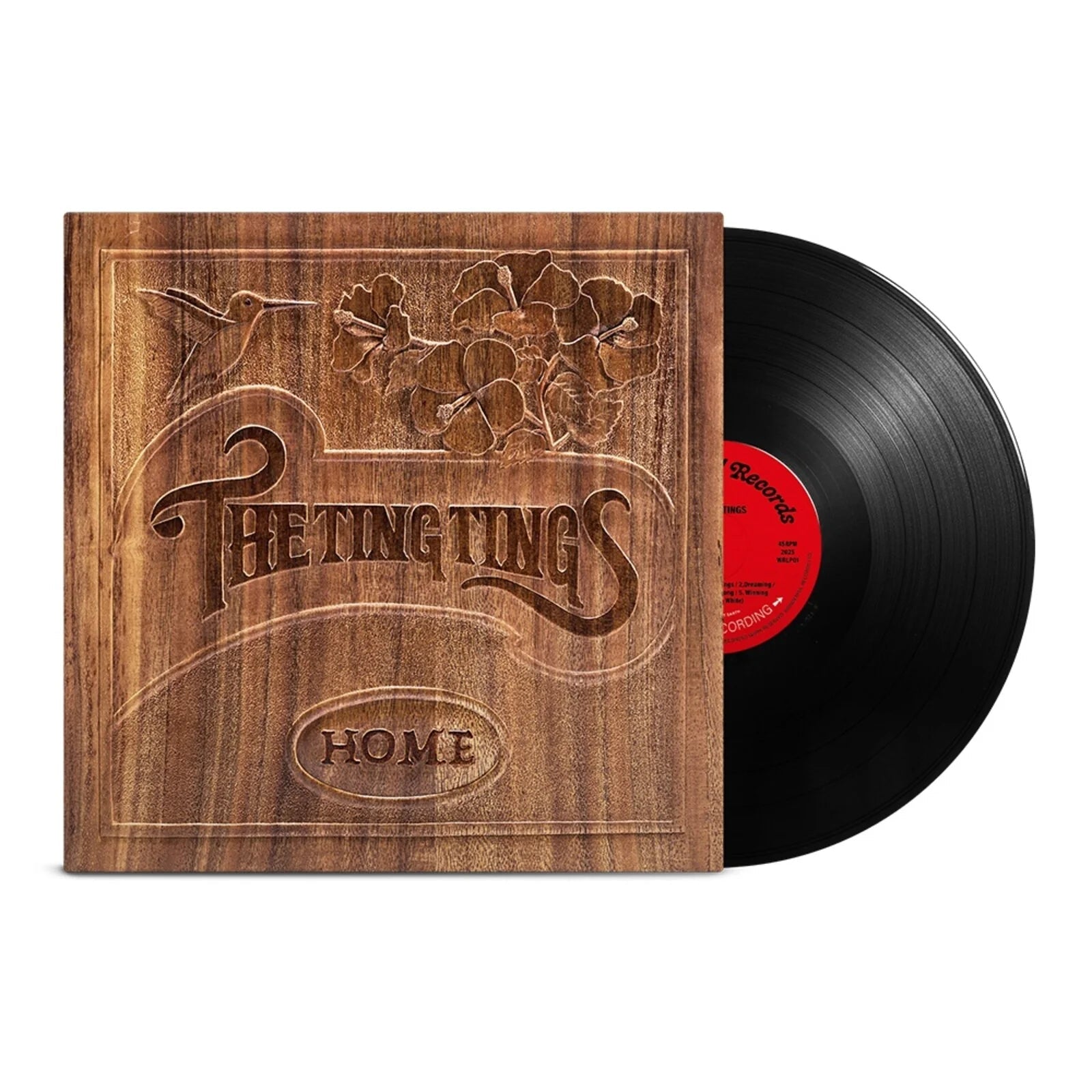Black vinyl record next to a wood-grain album cover featuring a hummingbird and flowers.