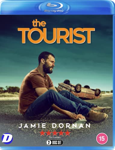 Blu-ray cover for "The Tourist" featuring Jamie Dornan sitting near wreckage.