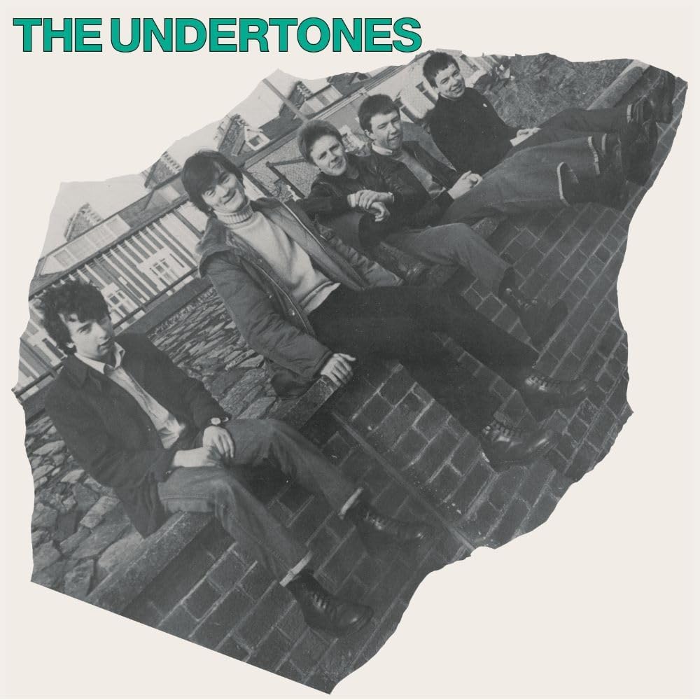 The Undertones band portrait on a CD cover, tilted brick background.