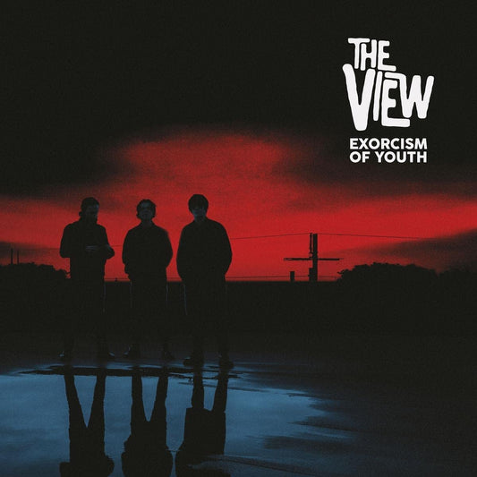 Silhouetted figures stand before a red and blue gradient sky.