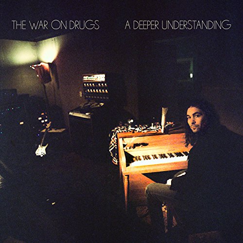 Album cover of "The War On Drugs - A Deeper Understanding" featuring a musician at a keyboard.