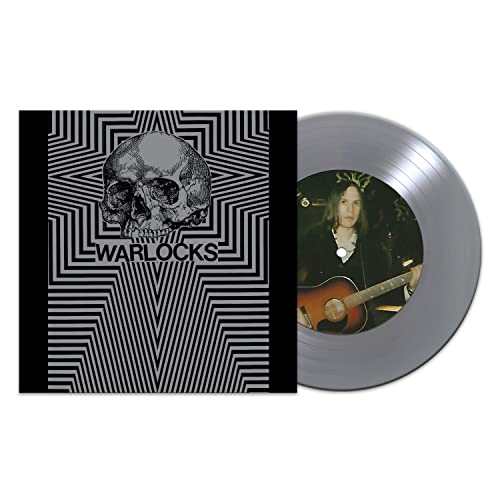 Vinyl record and sleeve featuring a skull and musician portrait.