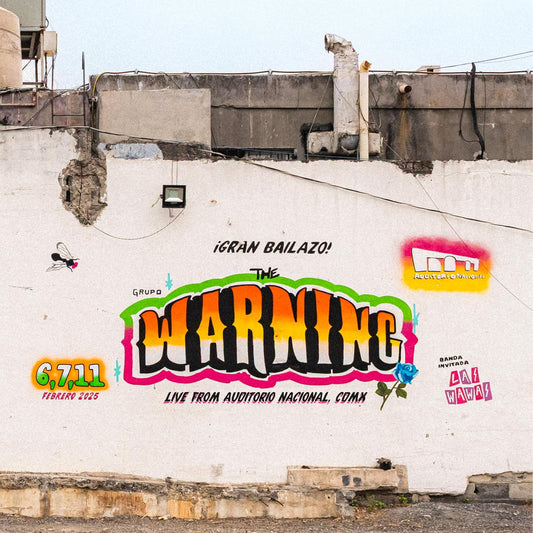 CD case cover featuring a weathered concrete wall with graffiti-style text for The Warning.