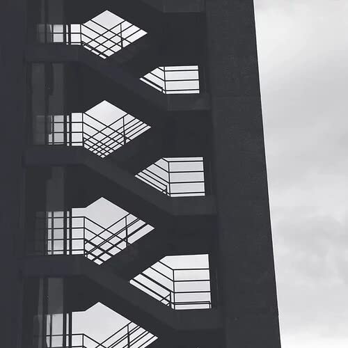 Black and white photo of a building’s exterior staircase detail.