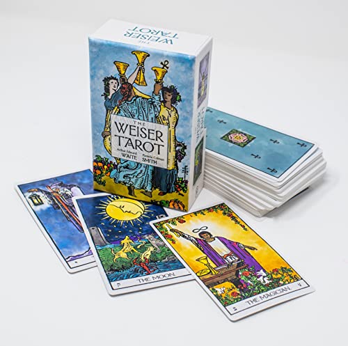 Tarot deck box and several cards displaying colorful, symbolic imagery.