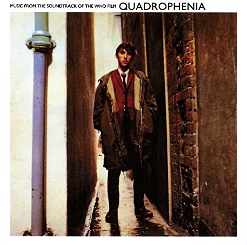 A young man in a parka stands in a narrow, dimly lit brick alleyway.