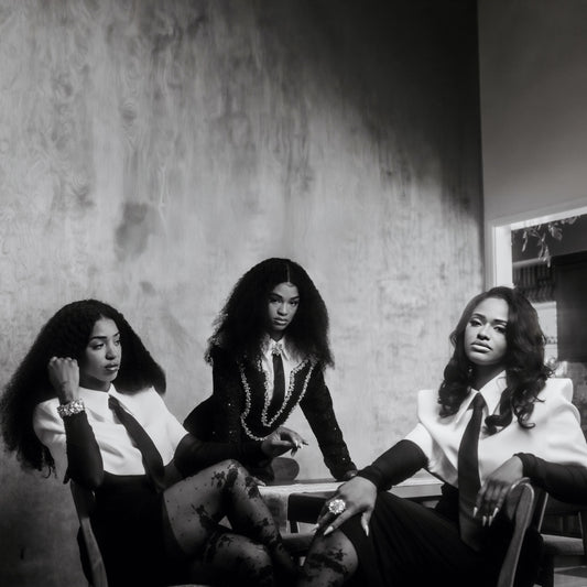 Black and white photo of three women with long, flowing hair.