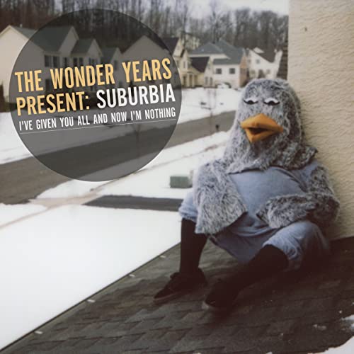 CD cover: person in animal costume sits in snowy suburbia.