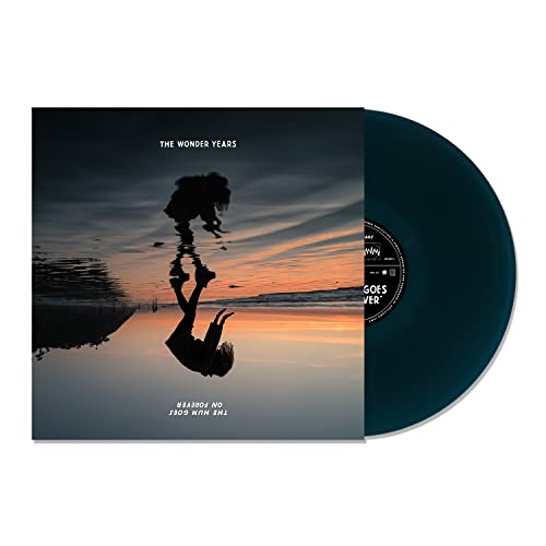 Vinyl record with album cover depicting a silhouetted figure by the ocean.