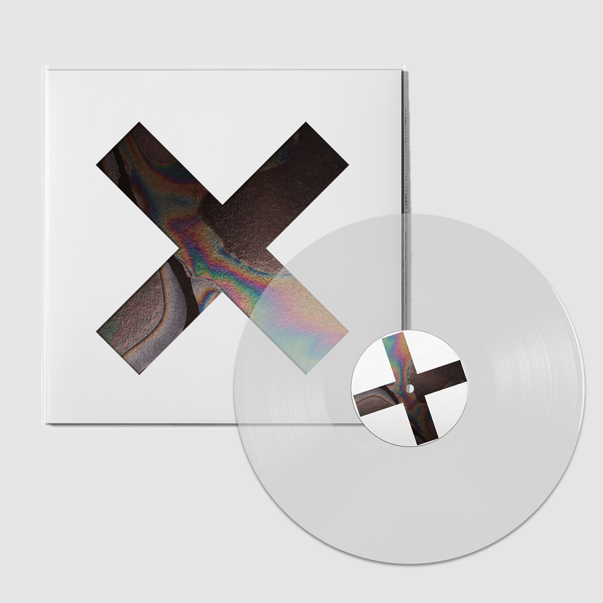 Clear vinyl LP with white cover featuring a large, colorful “x” design.