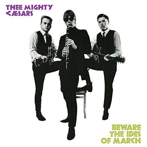 Black and white photo of three men with guitars and a clarinet.