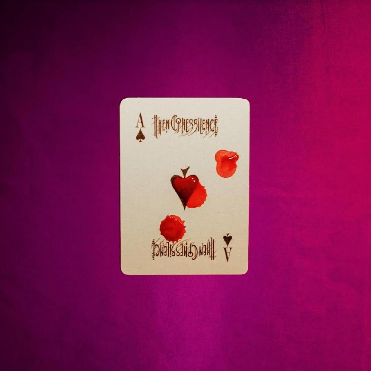 Ace of spades card with red blood-like splatters, album art.