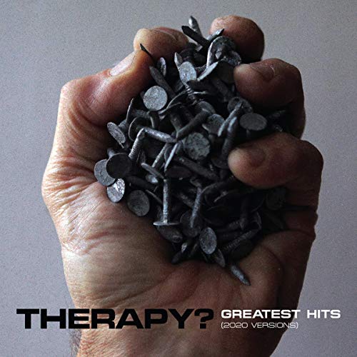 Hand holding a handful of rusty nails against a gray background.