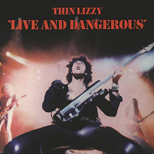 Album cover for Thin Lizzy’s “Live And Dangerous” featuring a guitarist onstage.