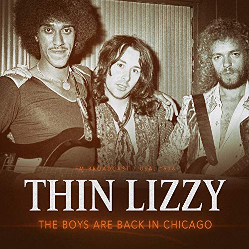Black and white photo of three men with long hair, album cover.