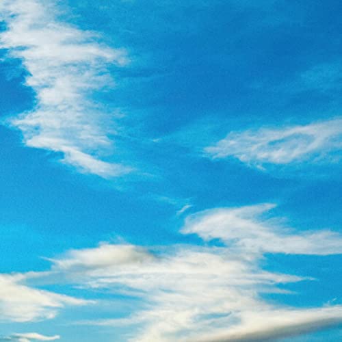 Vibrant blue sky with scattered white clouds.