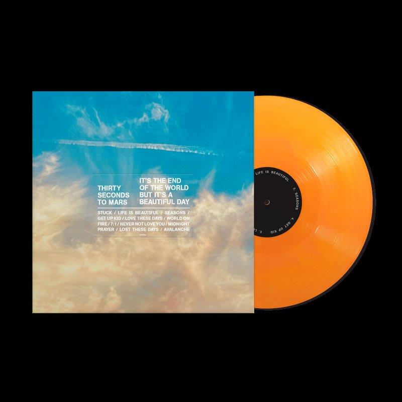 Orange vinyl record with album cover featuring cloudy sky and white text on blue background.