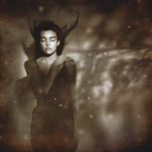 Sepia-toned portrait of a woman with closed eyes against a dark, ethereal, starry background.