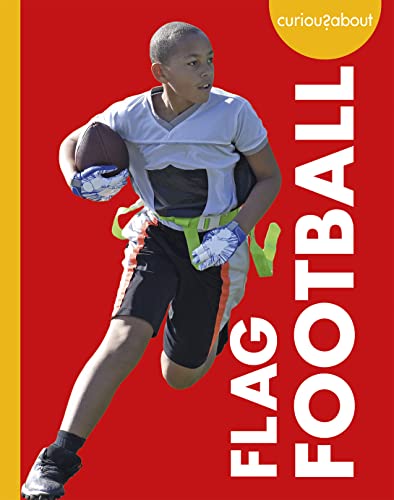 Boy running with a football, wearing flag football belts and gloves.