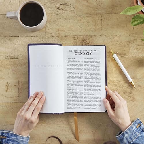 Open purple Bible with red lettering, hands holding pages, coffee nearby.