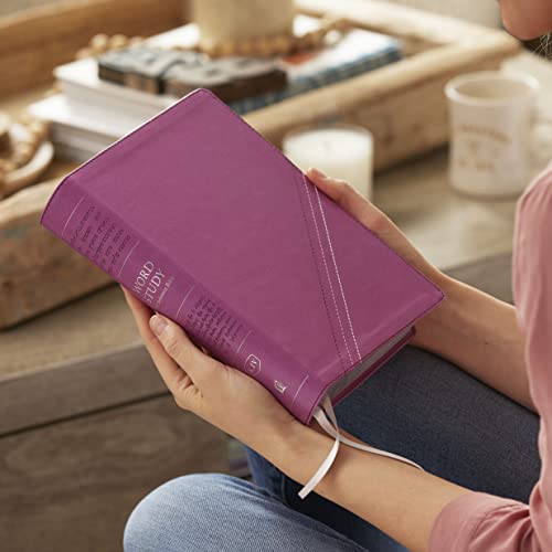 Pink leathersoft Bible held in hands, with white ribbon bookmark visible.