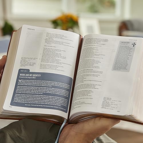 Open cream-colored Bible with red lettering, displaying text and study notes.