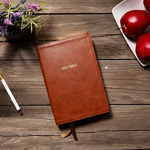 Brown leathersoft Bible with red page edges, resting on wood.