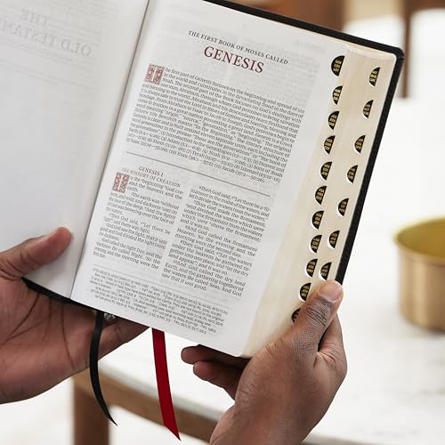 Open Bible to Genesis with thumb-indexing and a red ribbon bookmark.