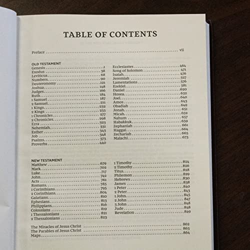 Open black hardcover Bible displaying the table of contents in red lettering.