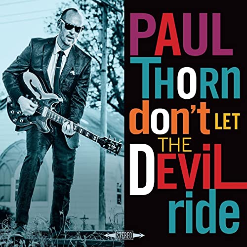 A man in a suit playing guitar stands before text reading Paul Thorn Don't Let The Devil Ride.