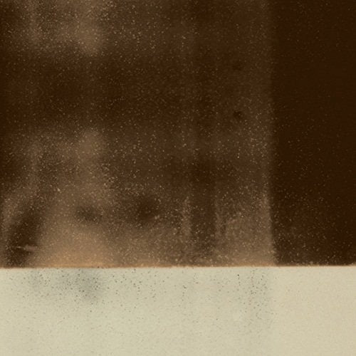 Dark, grainy texture with a white horizontal band at the bottom.