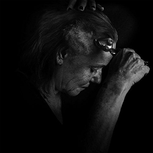 Black and white portrait of a person with a glass to their lips.