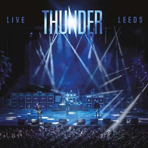 Thunder band performing live on stage with bright lights and audience.